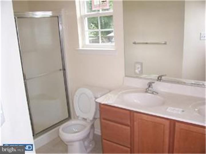 301 East Mill Road Maple Shade, NJ 08052 - Photo 10 of 10 a bathroom with a granite countertop sink toilet and a mirror