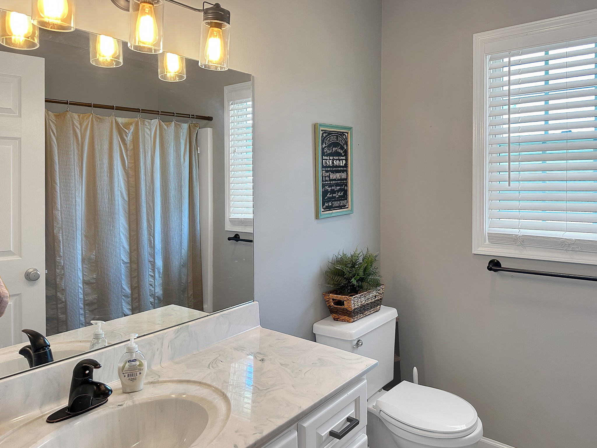 788 Van Dyke Grove Road Paris, TN 38242 - Photo 20 of 34 a bathroom with a granite countertop sink a toilet and mirror