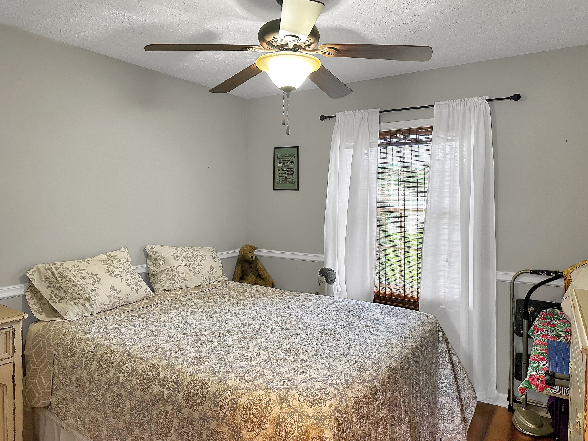 788 Van Dyke Grove Road Paris, TN 38242 - Photo 22 of 34 a bedroom with a bed and a chandelier