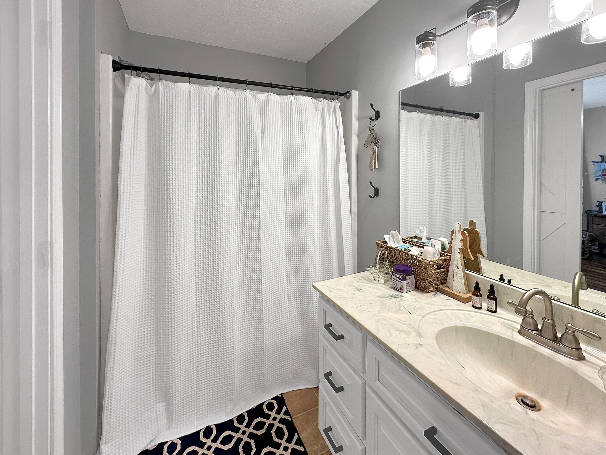 788 Van Dyke Grove Road Paris, TN 38242 - Photo 24 of 34 a bathroom with double vanity sink and a mirror