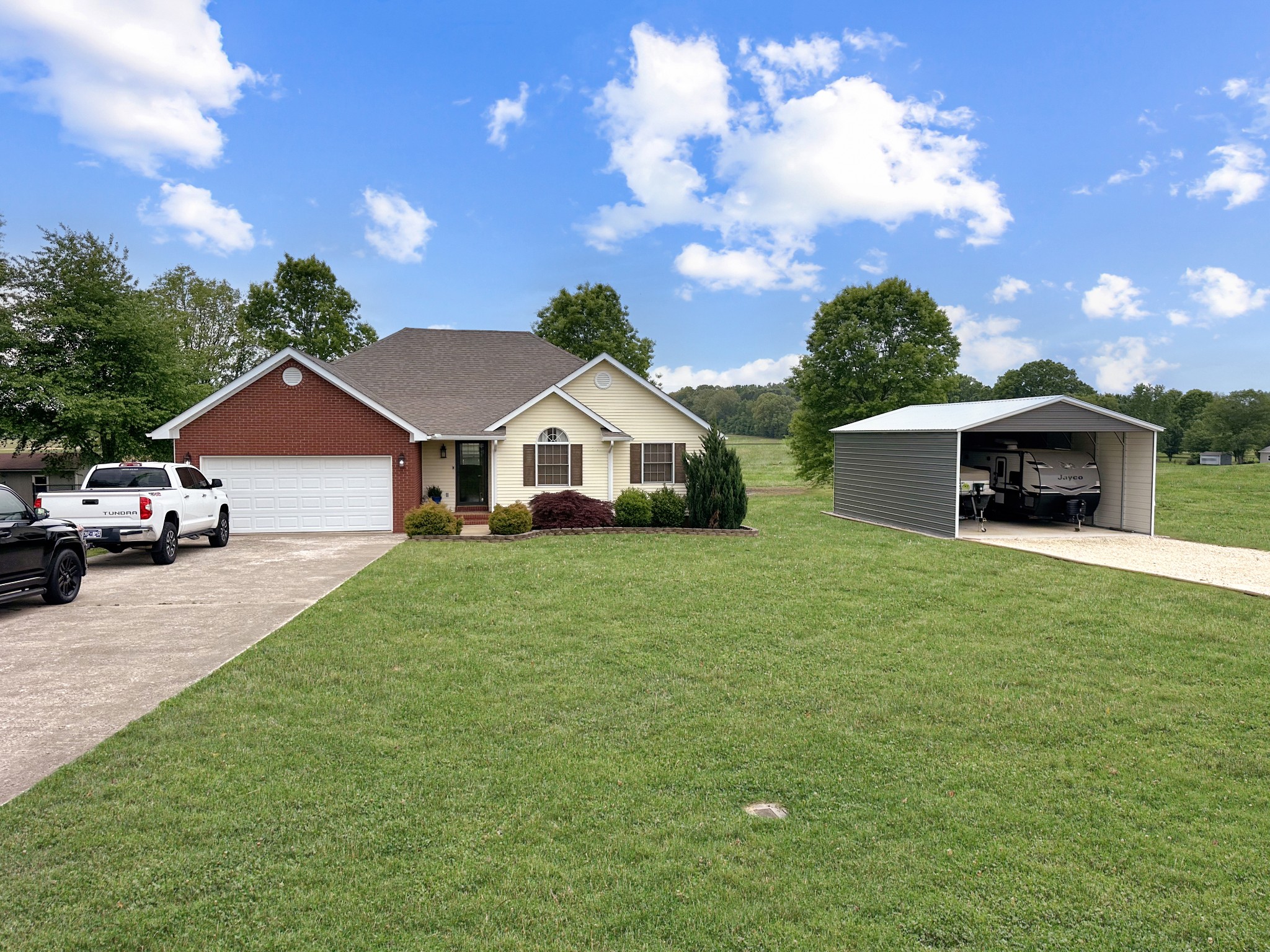 788 Van Dyke Grove Road Paris, TN 38242 - Photo 6 of 34 a front view of a house with a yard and garage