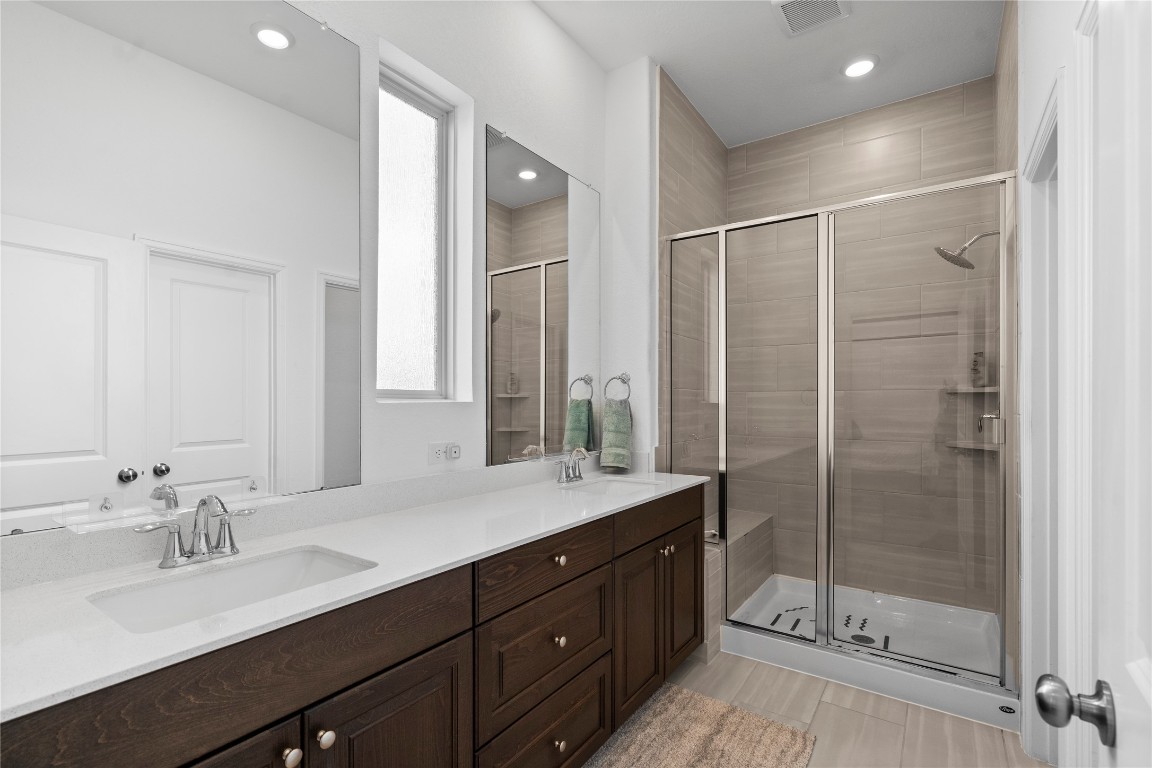 6025 Windward Fls Way Porter, TX 77365 - Photo 23 of 35 a bathroom with a shower sink vanity granite and mirror