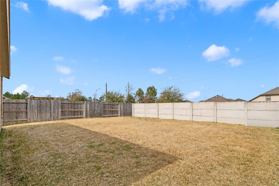 6025 Windward Fls Way Porter, TX 77365 - Photo 25 of 35 a view of a backyard