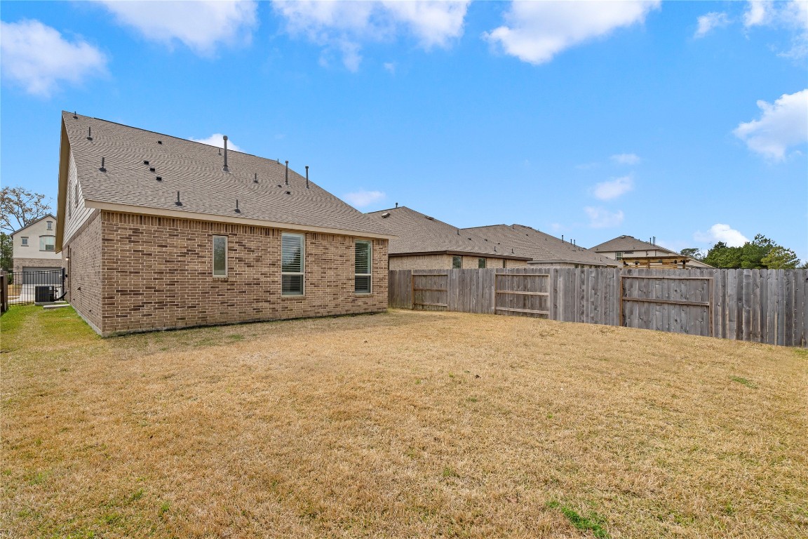 6025 Windward Fls Way Porter, TX 77365 - Photo 26 of 35 a front view of a house with a yard