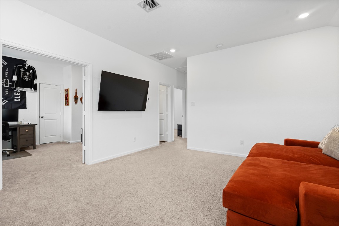 6025 Windward Fls Way Porter, TX 77365 - Photo 27 of 35 a projector room with a bed and a flat screen tv