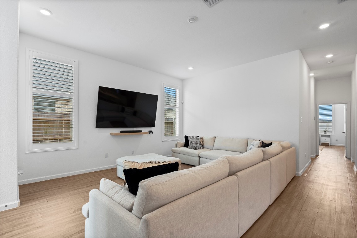 6025 Windward Fls Way Porter, TX 77365 - Photo 9 of 35 a living room with furniture and a flat screen tv