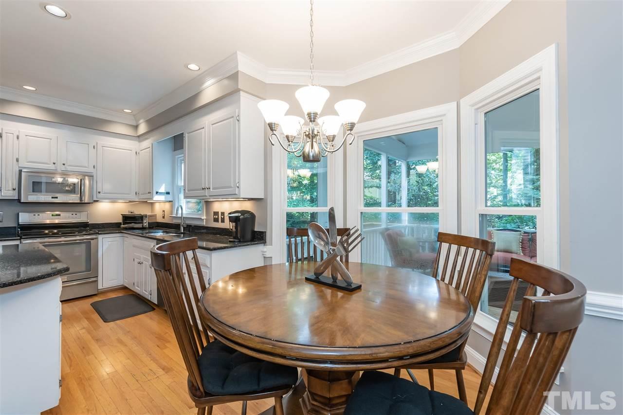 7904 Sandy Bottom Way Raleigh, NC 27613 - Photo 3 of 30 a view of a dining room with furniture a livingroom and chandelier