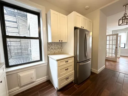a kitchen with stainless steel appliances granite countertop a refrigerator and a stove