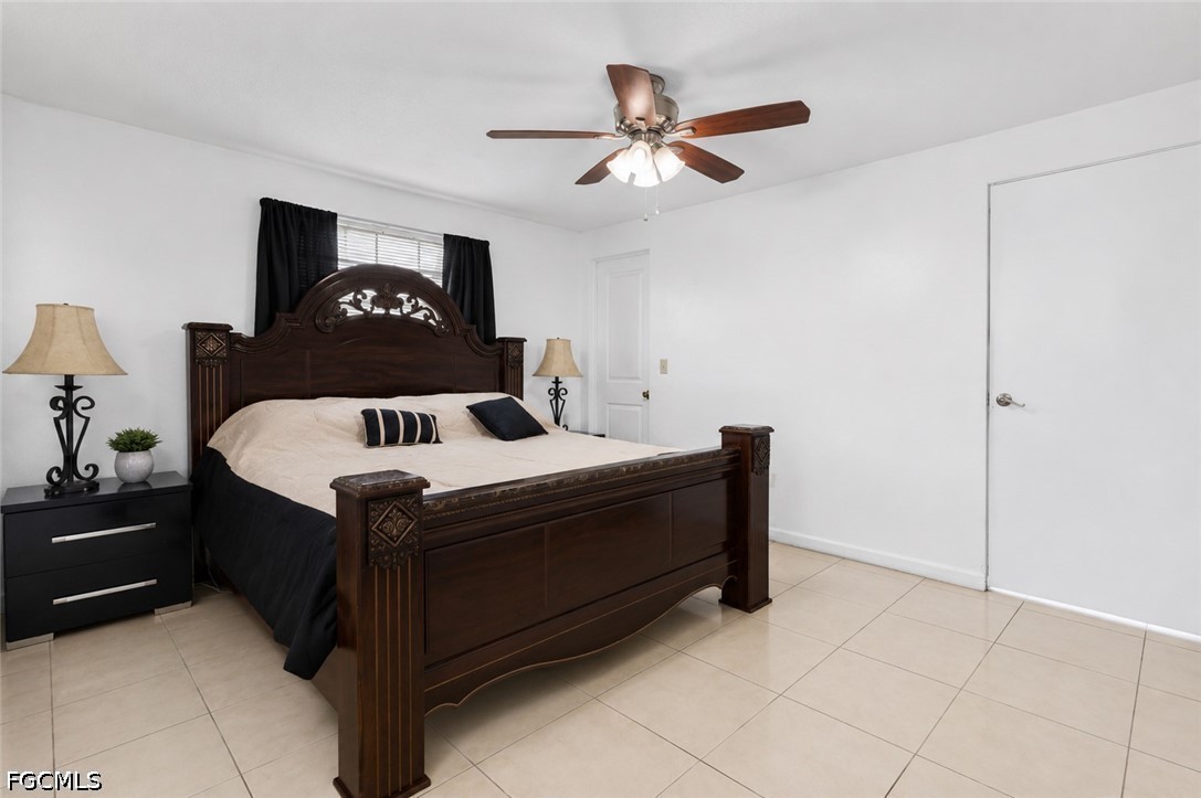 18 Illinois Road Lehigh Acres, FL 33936 - Photo 43 of 45 a bedroom with a bed and a dresser