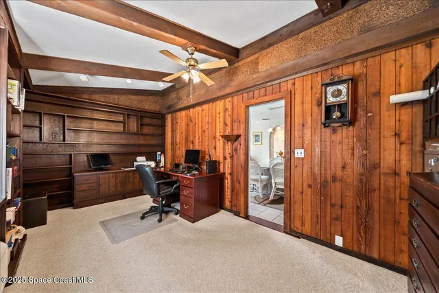 a view of a livingroom with workspace and a window