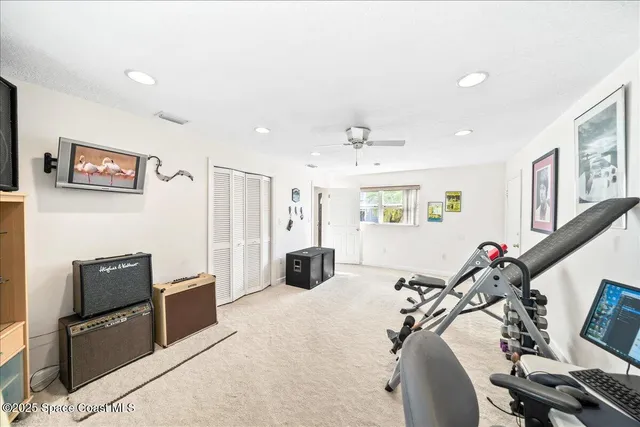 a large bedroom with bed and a large window