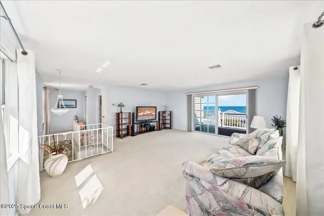 a spacious bedroom with a bed and a flat screen tv