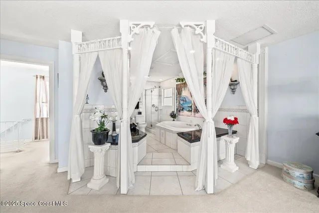 a bathroom with a tub sink and mirror