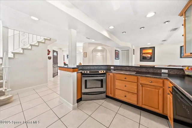 a kitchen with stainless steel appliances granite countertop a stove and a sink