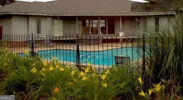 a view of swimming pool with a patio