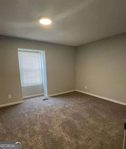 a view of an empty room and a window