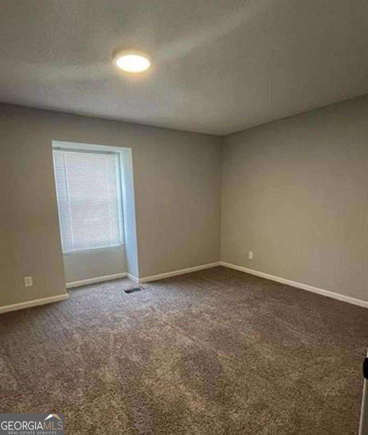 3730 Old Flowery Branch Road, Unit H3 Oakwood, GA 30566 - Photo 8 of 12 a view of an empty room and a window