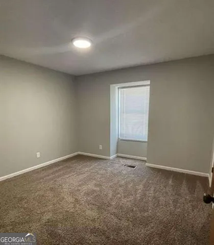 a view of an empty room and window