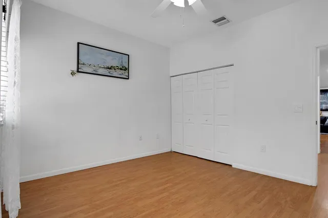 an empty room with a painting on the wall