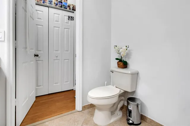 a white toilet sitting next to a bathroom sink