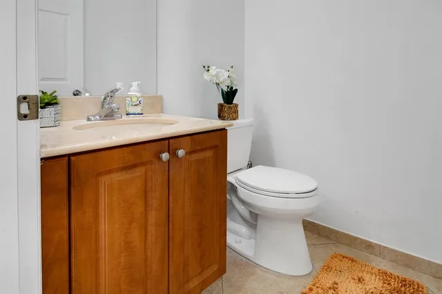 a bathroom with a sink a toilet and mirror
