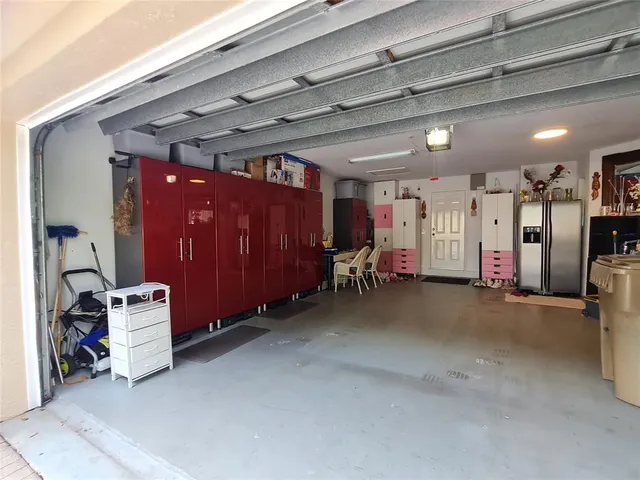 a view of a hallway with wooden floor and a bathroom