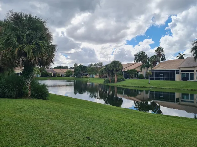 a front view of a house with a garden and garage