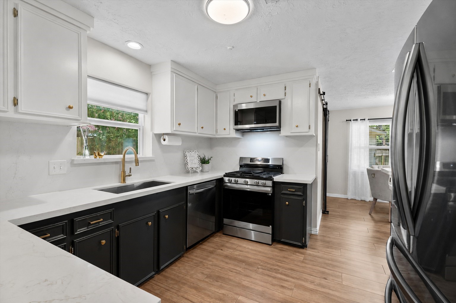 4026 Oxhill Road Spring, TX 77388 - Photo 11 of 40 At the heart of the home, the recently updated kitchen showcases timeless style with quartz countertops, stainless steel appliances, and warm brushed gold hardware—all thoughtfully designed for everyday living and effortless entertaining.