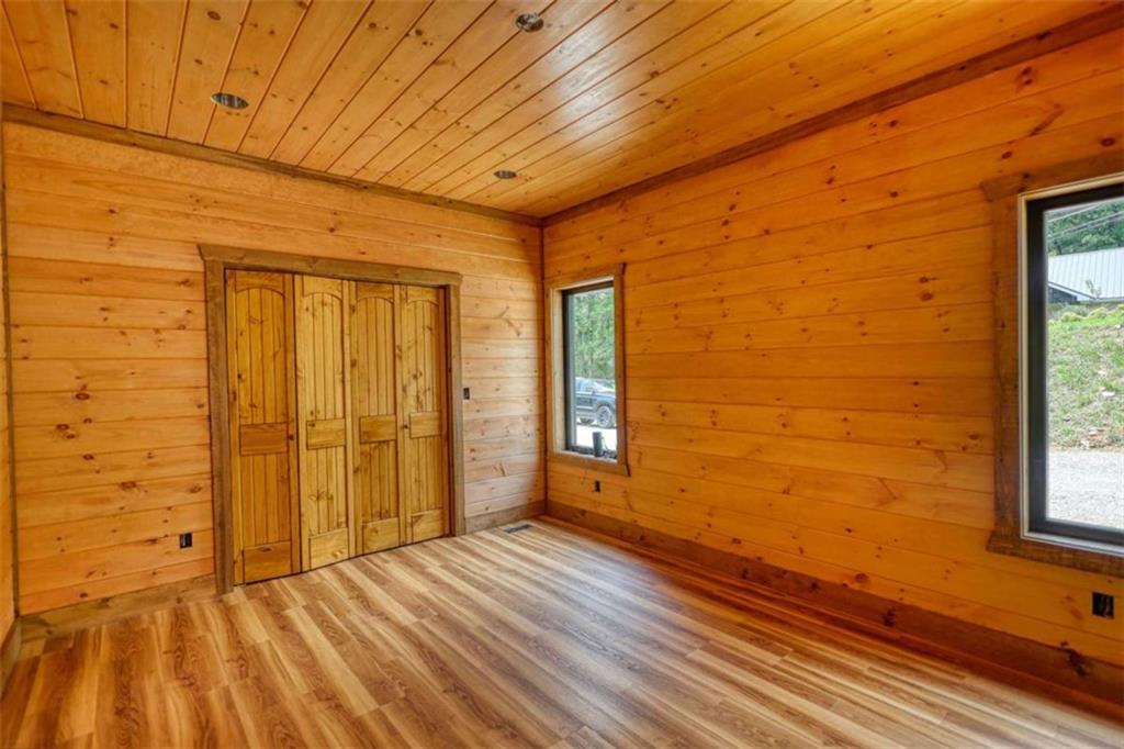 485 Church Street Blue Ridge, GA 30513 - Photo 15 of 85 a view of an empty room with wooden floor and a window