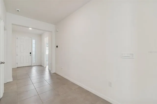 a kitchen with granite countertop a refrigerator sink and microwave