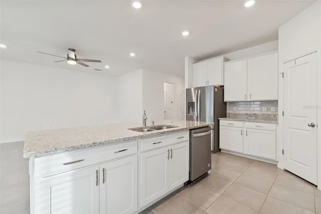 a kitchen with stainless steel appliances granite countertop a sink and a stove