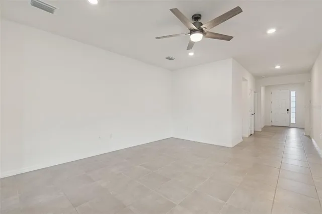an empty room with a ceiling fan and a ceiling fan