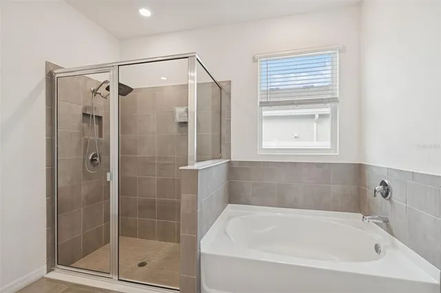 a bathroom with a shower and a mirror