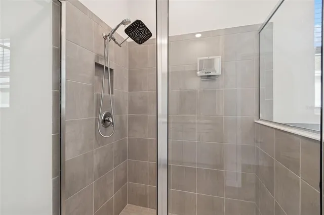 a bathroom with a white bath tub and a window