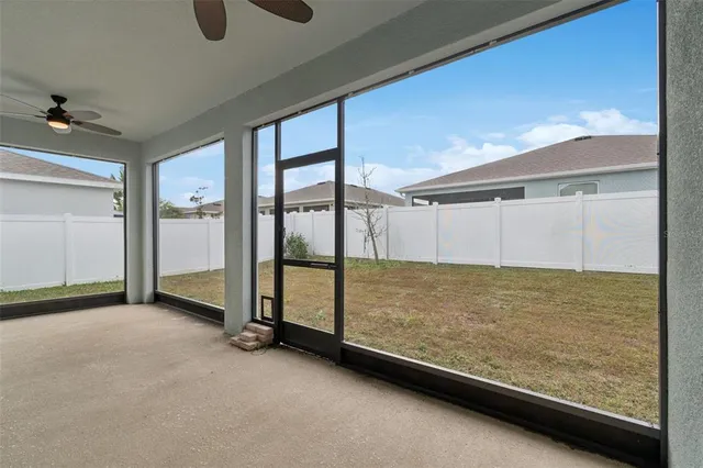 a view of empty room with ceiling fan