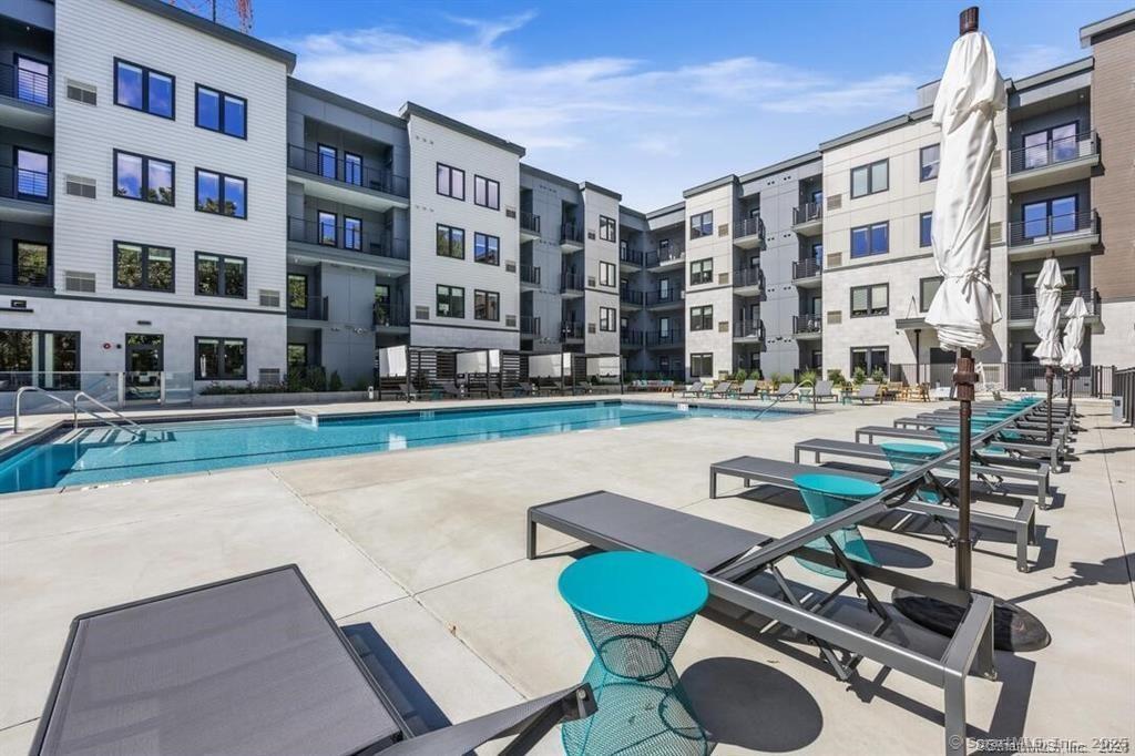 10 A Willard Road, Unit 456 Norwalk, CT 06851 - Photo 14 of 29 a front view of a building with swimming pool