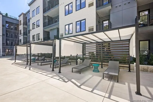 a view of a swimming pool and lounge chairs on th terrace