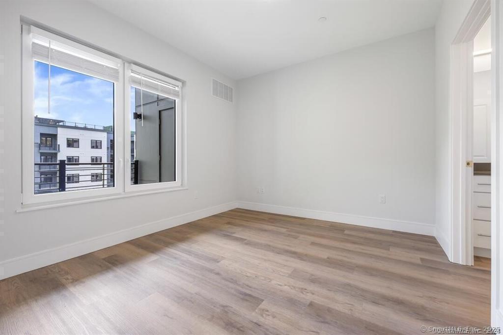 10 A Willard Road, Unit 456 Norwalk, CT 06851 - Photo 24 of 29 a view of an empty room with wooden floor and a window