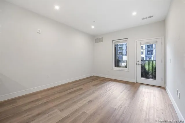 a view of kitchen with refrigerator and microwave