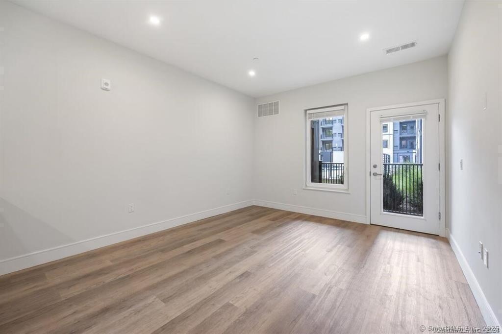 10 A Willard Road, Unit 456 Norwalk, CT 06851 - Photo 26 of 29 a view of an empty room with wooden floor and a window