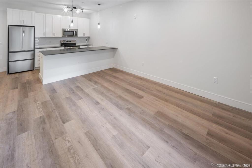 10 A Willard Road, Unit 456 Norwalk, CT 06851 - Photo 27 of 29 a view of kitchen with refrigerator and microwave
