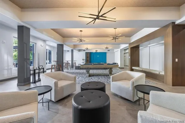 a living room with furniture a ceiling fan and a rug