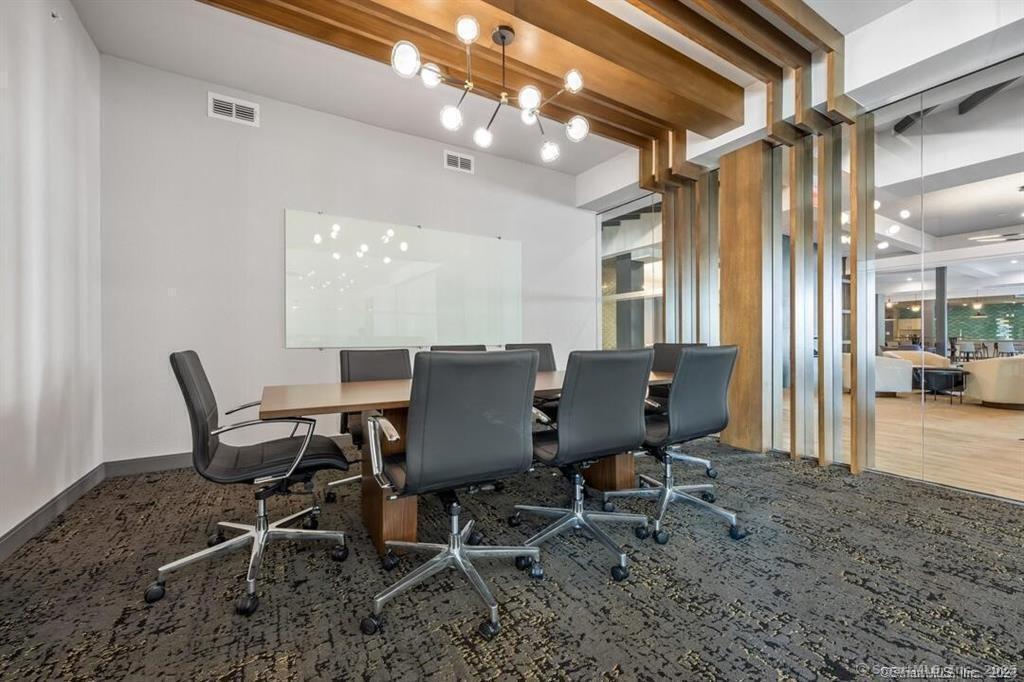 10 A Willard Road, Unit 456 Norwalk, CT 06851 - Photo 8 of 29 a view of a dining room with furniture and a chandelier