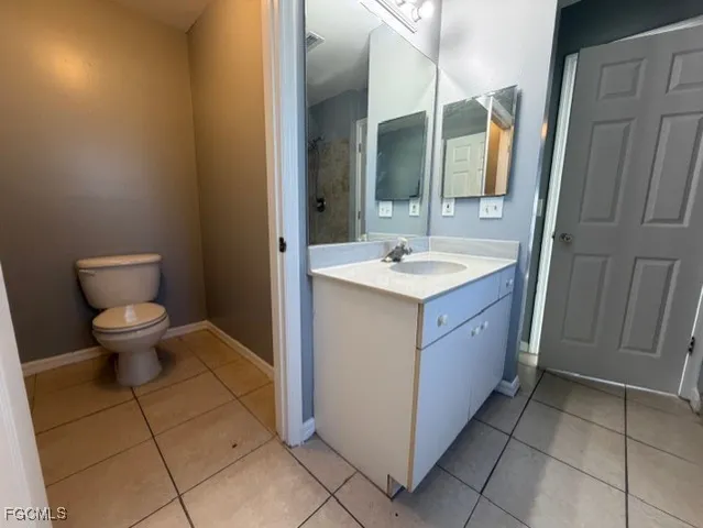 a room with a sink a toilet and mirror