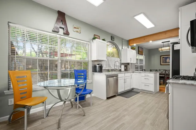 a kitchen with stainless steel appliances a stove a microwave and cabinets