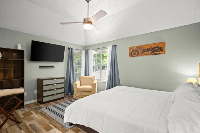 a bedroom with a large bed and a window