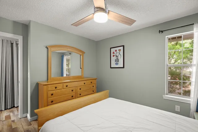 a view of hallway with wooden floor and chandelier