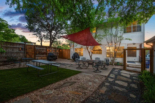 a view of backyard with swimming pool and sitting area