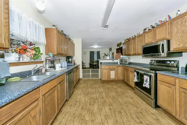 a kitchen with stainless steel appliances granite countertop a sink stove and refrigerator