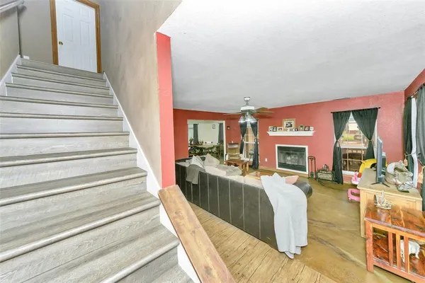 a living room with fireplace furniture and a fireplace